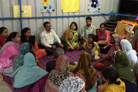 The director, Samiur Rahman, advises women in an outlying district on how to develop women's empowerment